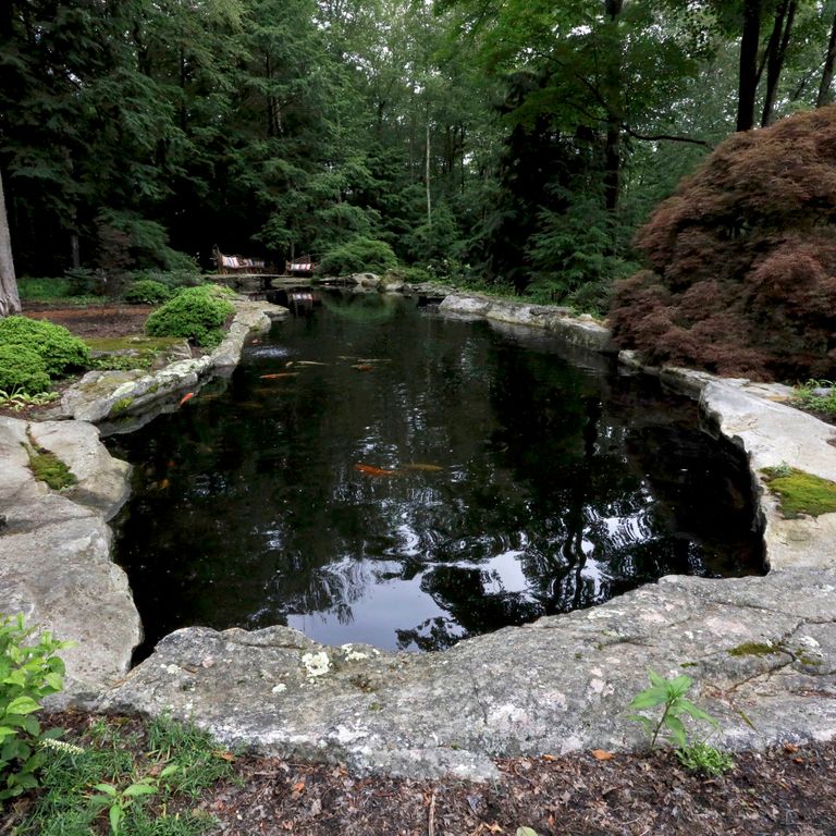 Application image for Fieldstone - New England Boulders - Pool/Pond Coping. The image shows this product being used in a pool coping application. The surface finish shown is weathered. The dominant color shown is gray. The color mix creates a warm feeling.