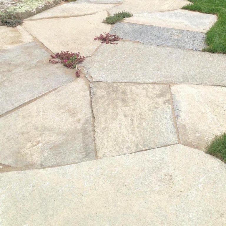 Close-up image for Tidewater Granite Oversized Pavers. The surface finishes shown are split-face with flat plane and weathered. Dominant colors shown are beige and cream; with gray, white and tan secondaries. The color mix creates a warm feeling. Random, blotched and cloudy color patterns.