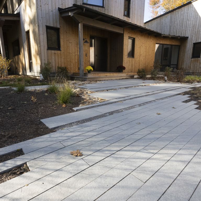 Feature image for Limestone - Polar Gray - Dimensional Cut Pavers. The image shows this product being used in a path pavers application. The dominant color shown is gray. The color mix creates a cool feeling.