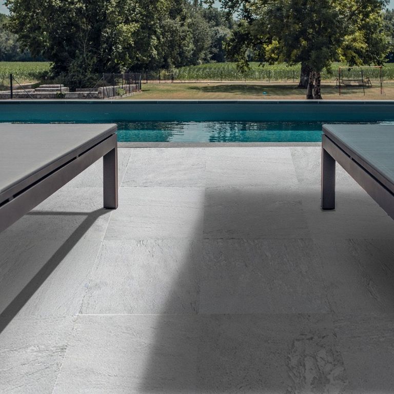 Application image for Slate - Iberian Gray - Pavers. The image shows this product being used in a patio pavers application. Dominant colors shown are black and gray. The color mix creates a cool feeling.