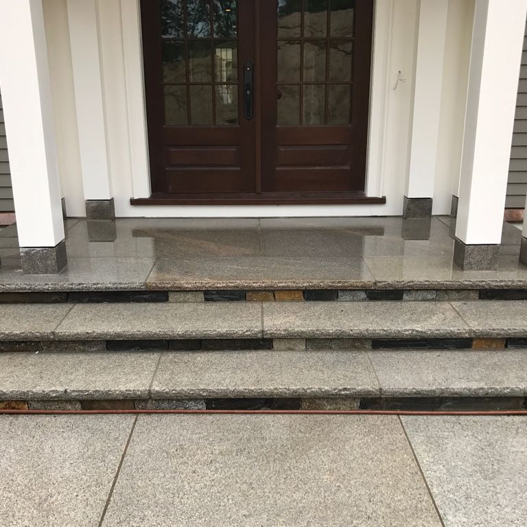 Application image for Cape Neddick Granite Clear - Rockfaced Treads. The image shows this product being used in a treads application. This is a building and landscape stone for indoor and outdoor commercial and residential applications. Suitable for general use, freeze-thaw conditions, low heat absorption surfaces, high traffic areas, low slipperiness surfaces and high heel compatibilty situations. Moderate to higher on the price spectrum.