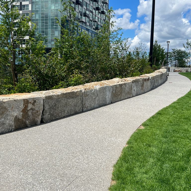 Application image for Reclaimed Granite Block - Seating Walls. The image shows this product being used for seating & benches and landscape curbing & edging. The dominant color shown is gray.
