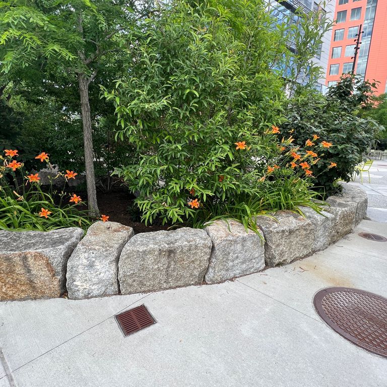 Application image for Reclaimed Granite Block - Seating Walls. The image shows this product being used for seating & benches and landscape curbing & edging. The dominant color shown is gray.