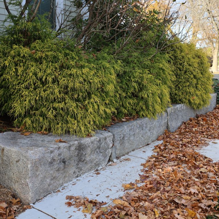 Application image for Reclaimed Granite Block - Seating Walls. The image shows this product being used for seating & benches and landscape curbing & edging. The surface finish shown is . The dominant color shown is gray. The color mix creates a warm feeling.