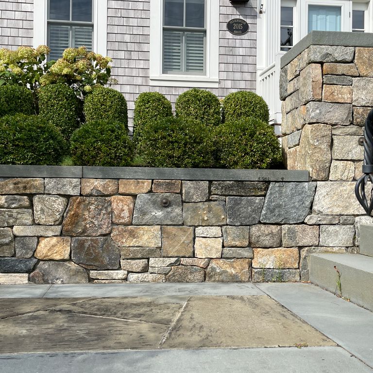 Application image for New England Fieldstone Mix - Veneer. The image shows this product being used in a thin veneer application. The surface finish shown is weathered. The dominant color shown is gray. The color mix creates a warm feeling.