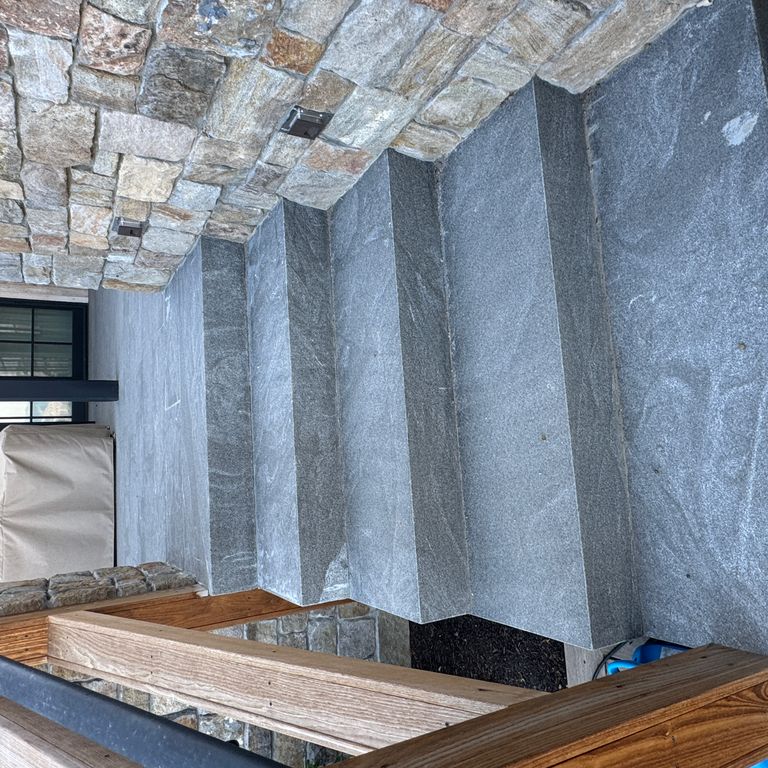 Application image for Granite - Jet Mist - Steps and Treads. The image shows this product being used in a monolithic steps application. The dominant color shown is gray. The color mix creates a cool feeling.