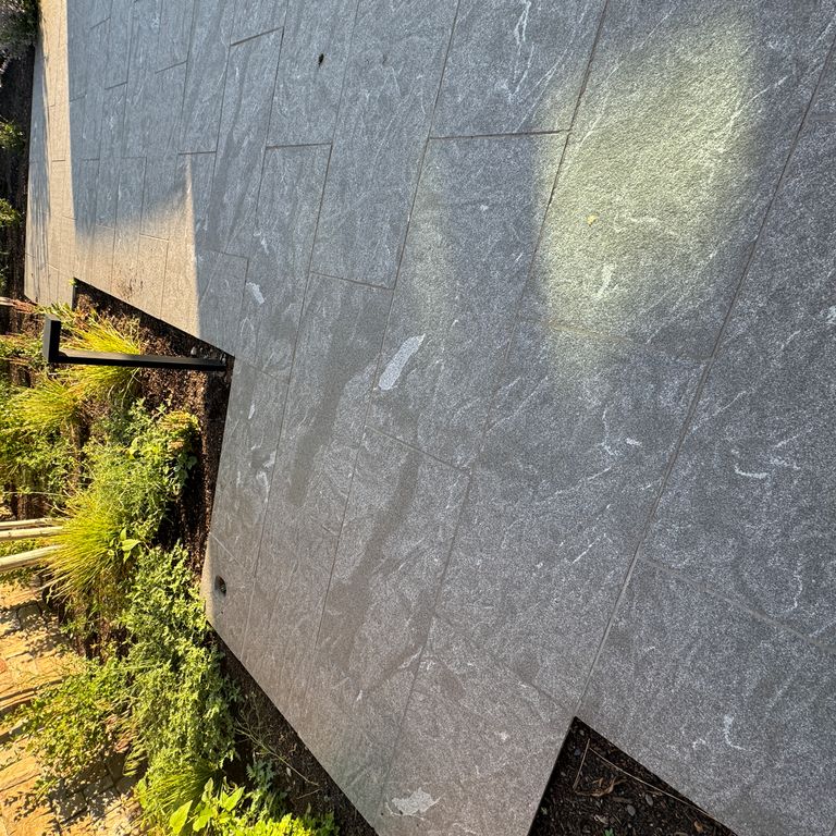 Feature image for Granite - Jet Mist - Pavers. The image shows this product being used in a path pavers application. The dominant color shown is gray. The color mix creates a warm feeling.