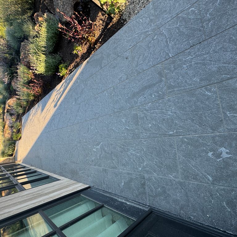 Application image for Granite - Jet Mist - Pavers. The image shows this product being used in a path pavers application. The dominant color shown is gray. The color mix creates a warm feeling.