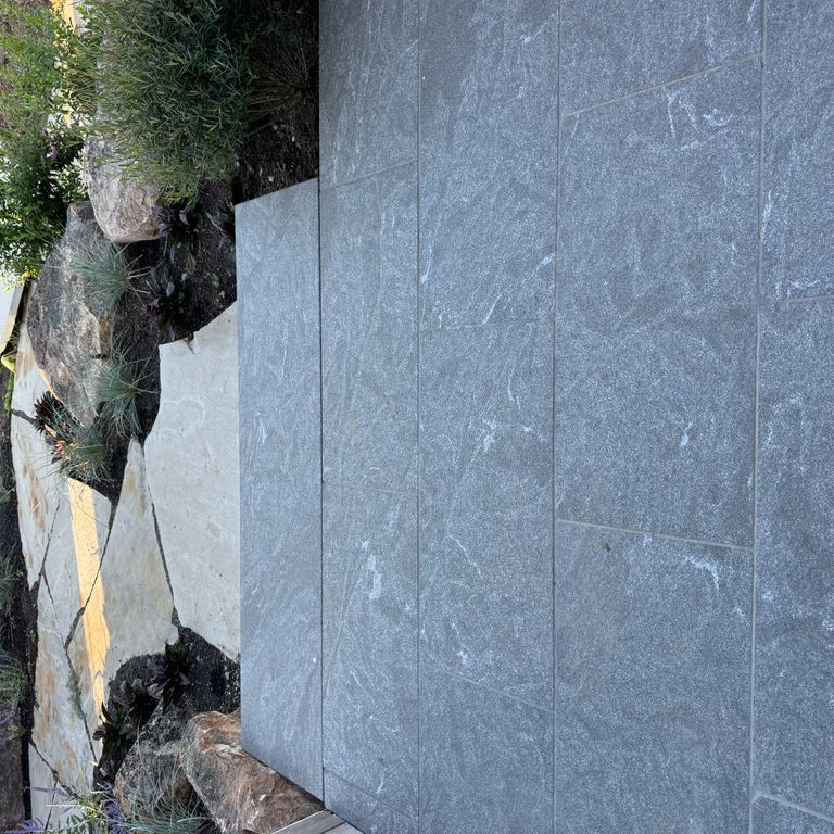 Application image for Granite - Jet Mist - Pavers. The image shows this product being used in a path pavers application. The dominant color shown is gray. The color mix creates a warm feeling.