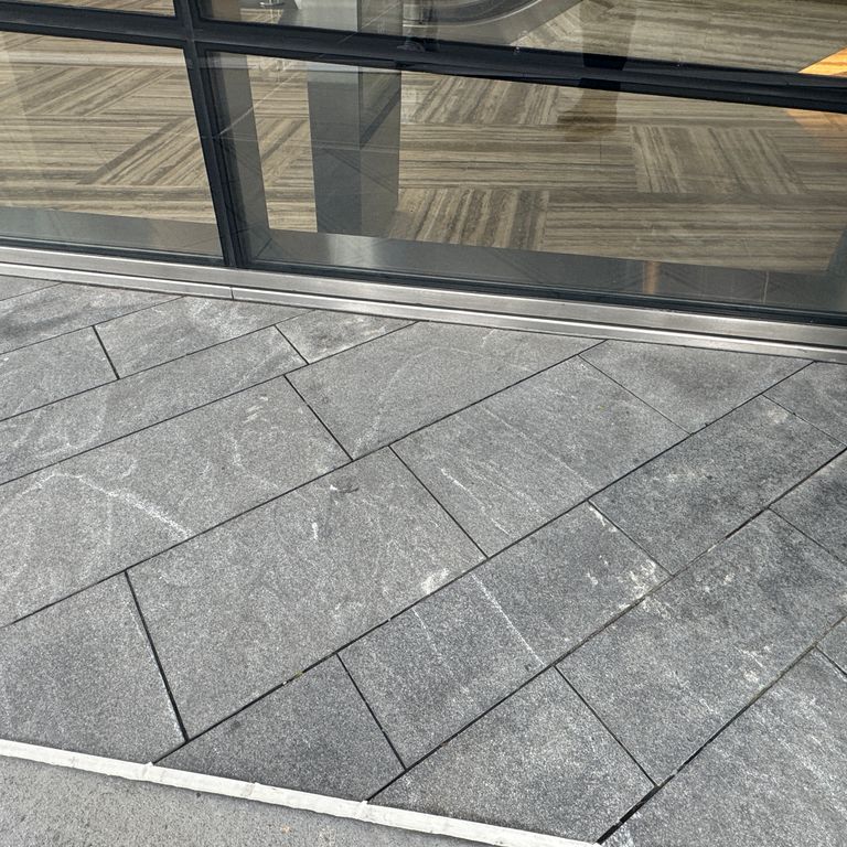 Application image for Granite - Jet Mist - Pavers. The image shows this product being used in a path pavers application. The dominant color shown is gray.