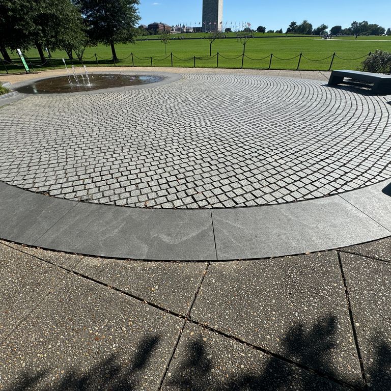 Application image for Granite - Jet Mist - Pavers. The image shows this product being used in a path pavers application. The dominant color shown is gray. The color mix creates a warm feeling.
