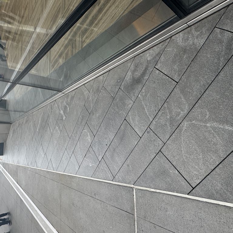 Application image for Granite - Jet Mist - Pavers. The image shows this product being used in a path pavers application. The dominant color shown is gray. The color mix creates a cool feeling.