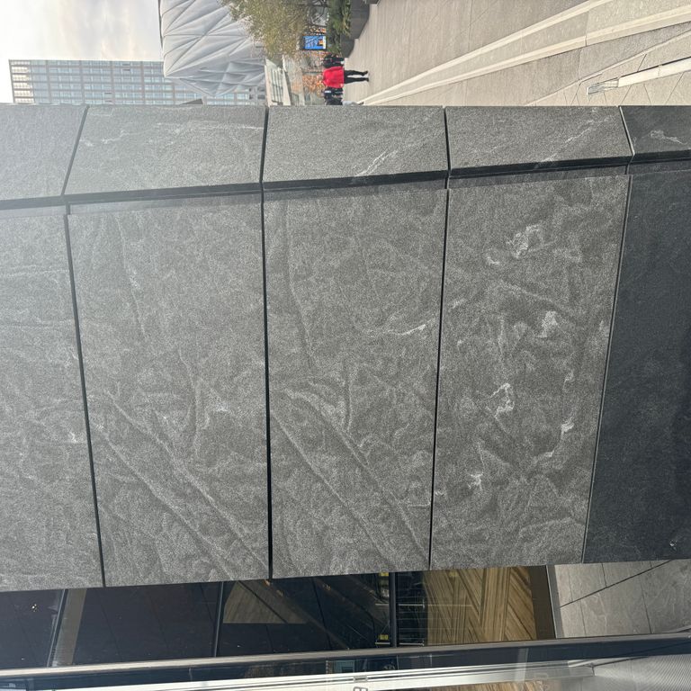 Application image for Jet Mist Granite - Wall Cladding. The image shows this product being used in an interior cladding application. The dominant color shown is gray.