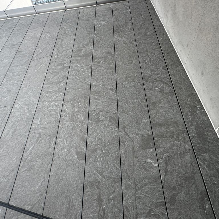 Application image for Jet Mist Granite - Wall Cladding. The image shows this product being used in an interior cladding application. The dominant color shown is gray. The color mix creates a cool feeling.
