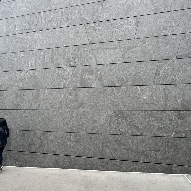 Application image for Jet Mist Granite - Wall Cladding. The image shows this product being used in an interior cladding application. The dominant color shown is gray. The color mix creates a cool feeling.