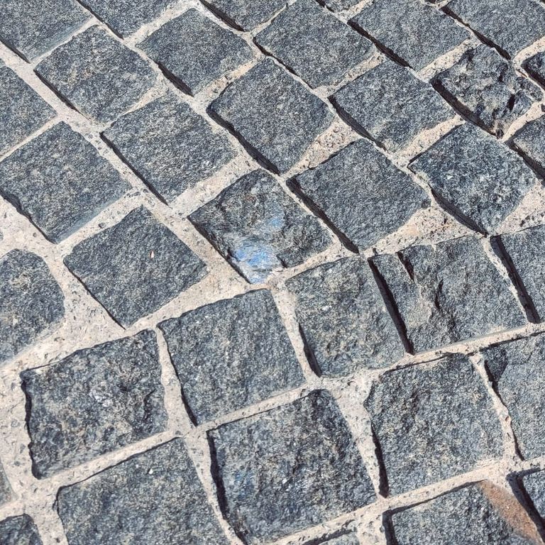 Feature image for Labradorite Blue Seven Oceans - Natural Cobblestones. The image shows this product being used in a patio pavers application. The surface finish shown is split-face. Dominant colors shown are blue and gray. The color mix creates a cool feeling.
