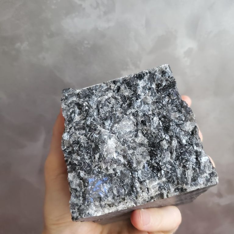 Application image for Labradorite Blue Seven Oceans - Natural Cobblestones. The surface finish shown is split-face. Dominant colors shown are black and gray. The color mix creates a cool feeling.