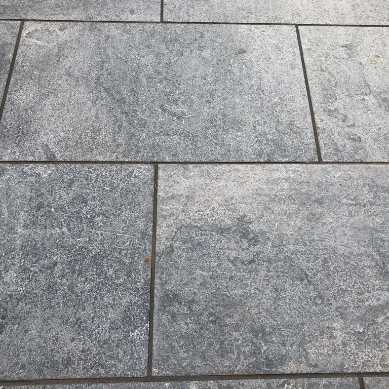Application image for Highland Limestone - Flamed Pavers. The image shows this product being used in a patio pavers application. The dominant color shown is gray. The color mix creates a cool feeling.