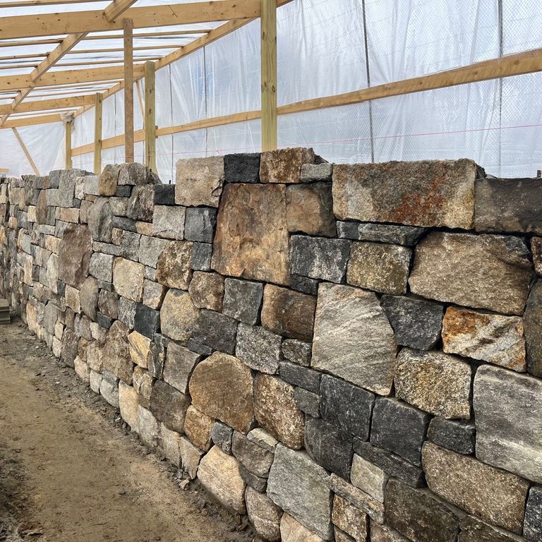 Application image for New England Fieldstone - Barre Dark Veneer. The image shows this product being used for full bed veneer and thin veneer. The surface finish shown is weathered. Dominant colors shown are brown and tan. The color mix creates a warm feeling.
