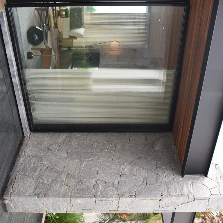 Application image for Brazilian Lucerna Gneiss - Flamed Pavers. The image shows this product being used in a patio pavers application. The surface finish shown is flamed. The dominant color shown is gray. The color mix creates a warm feeling.