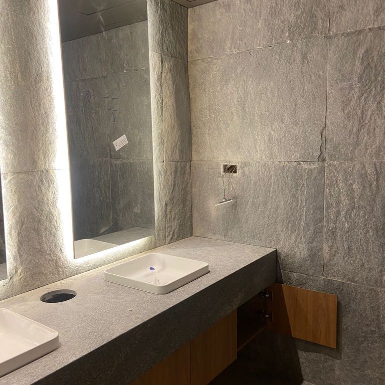 Application image for Brazilian Lucerna Gneiss - Interior Wall Cladding. The image shows this product being used in an interior cladding application. The surface finish shown is split-face. The dominant color shown is gray. The color mix creates a warm feeling.