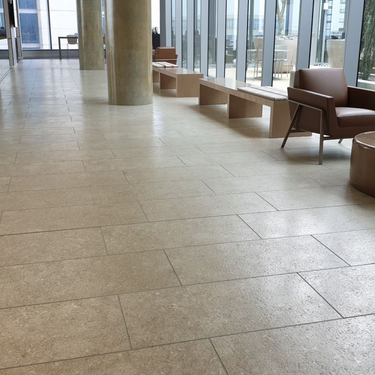 Application image for Veneto Olivo Limestone - Interior Flooring. The image shows this product being used in an interior floor application. The surface finish shown is . Dominant colors shown are gray and tan. The color mix creates a warm feeling.