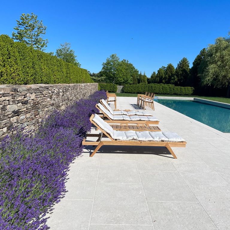 Application image for Veneto Olivo Limestone - Pool Coping. The image shows this product being used for pool coping and pool deck pavers. The surface finish shown is flamed. The dominant color shown is gray. The color mix creates a warm feeling.