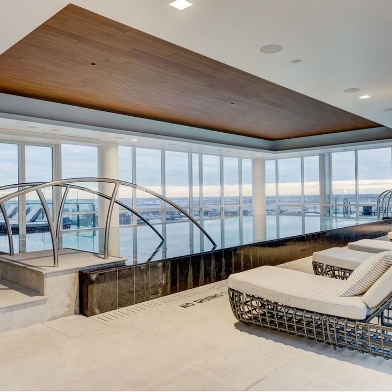 Application image for Veneto Olivo Limestone - Pool Coping. The image shows this product being used in an interior floor application. The surface finish shown is flamed. Dominant colors shown are gray and tan. The color mix creates a warm feeling.