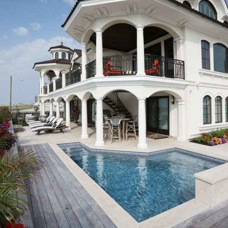 Feature image for Veneto Beige Limestone - Pool Coping. The image shows this product being used for pool coping and pool deck pavers. The surface finish shown is flamed. Dominant colors shown are beige, white and cream; with blue, pink and tan secondaries. The color mix creates a warm feeling. Regular color pattern. Contains mineral inclusions.