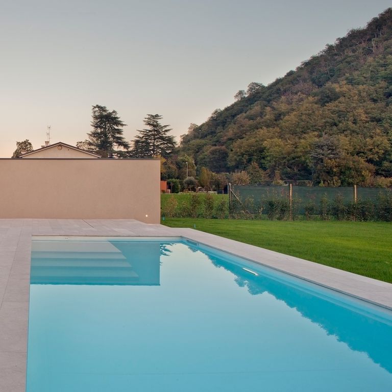 Application image for Veneto Beige Limestone - Pool Coping. The image shows this product being used for pool coping and pool deck pavers. The surface finish shown is flamed. Dominant colors shown are beige and tan. The color mix creates a warm feeling.