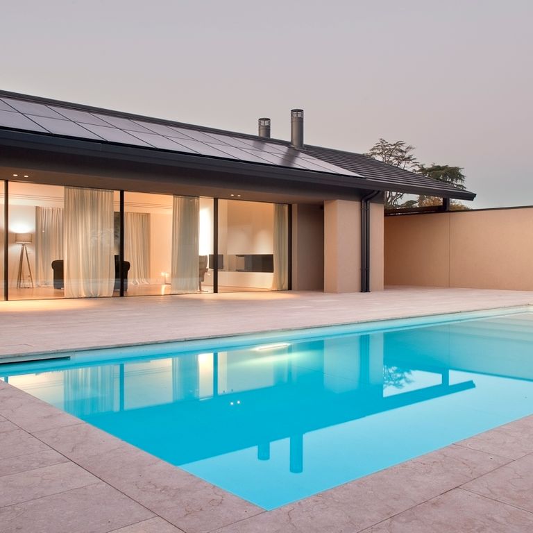 Application image for Veneto Beige Limestone - Pool Coping. The image shows this product being used for pool coping and pool deck pavers. The surface finish shown is flamed. Dominant colors shown are beige, tan and cream. The color mix creates a warm feeling.